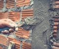 Bricklaying. Construction worker building a brick wall.