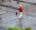 Construction building workers working at the site in a cloudy day