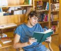 male-teenager-reading-chair