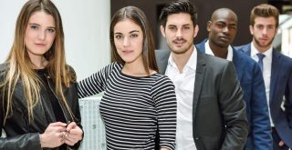 Multi-ethnic and confident business team standing in an office building